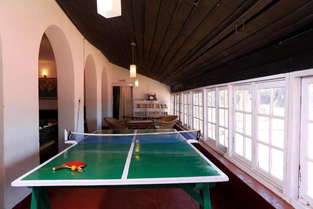 a ping pong table in the middle of a room at Parisons Plantation Experiences by Abad in Mananthavady