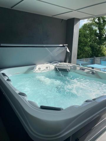 a bath tub with blue water in a room at The Hideaway Portaferry in Portaferry