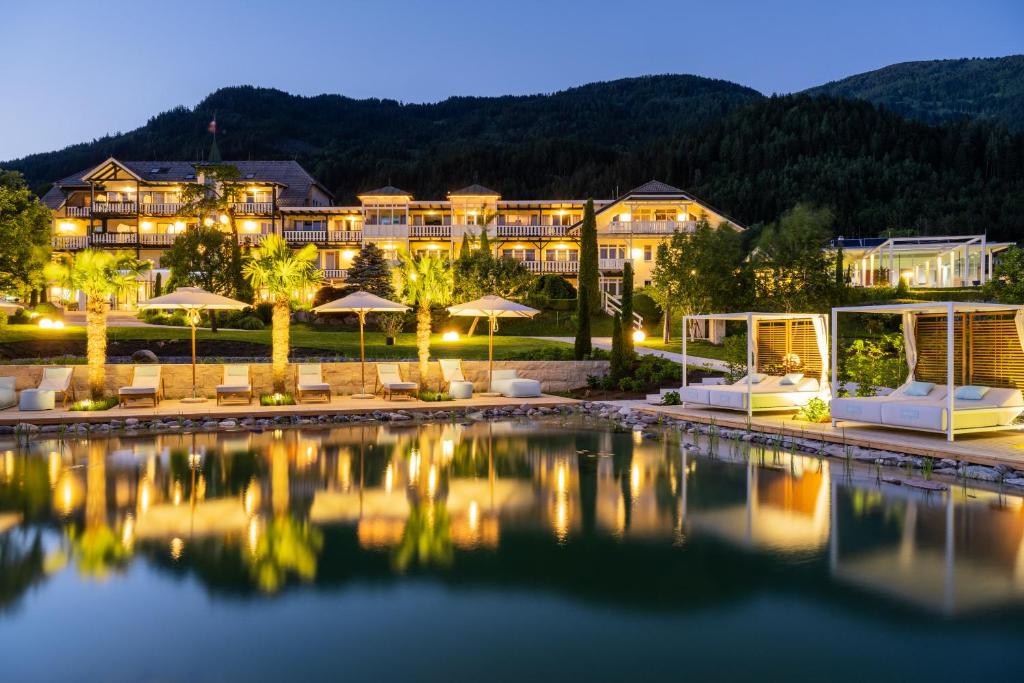 a hotel with a pool in front of a resort at Das Moerisch in Seeboden