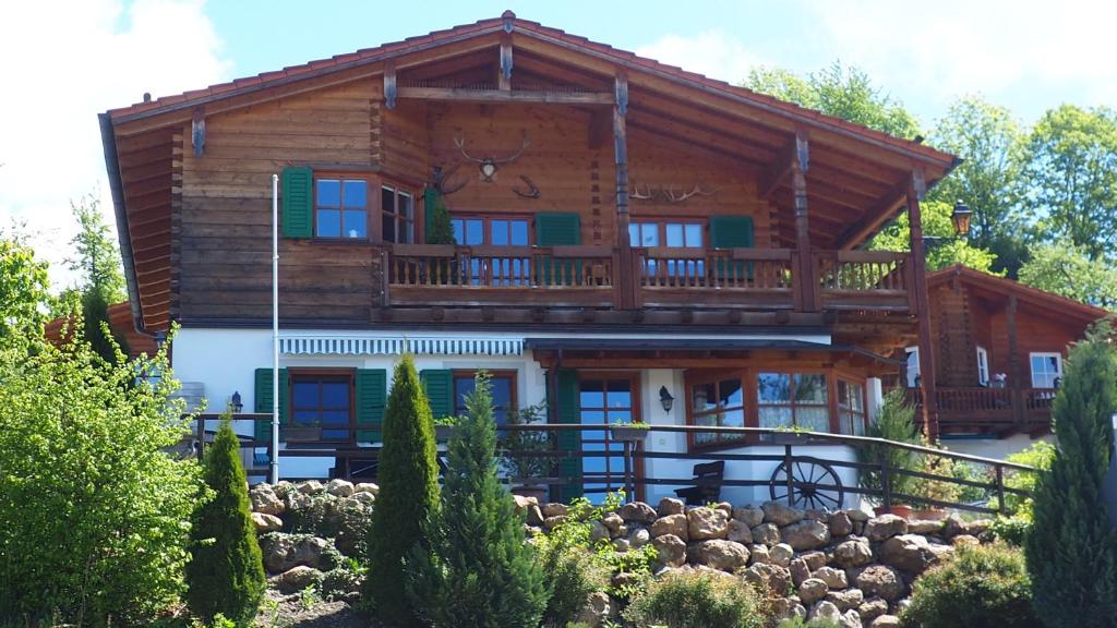 a log house with a balcony on top of it at Golfchalet Uttlau in Bad Griesbach