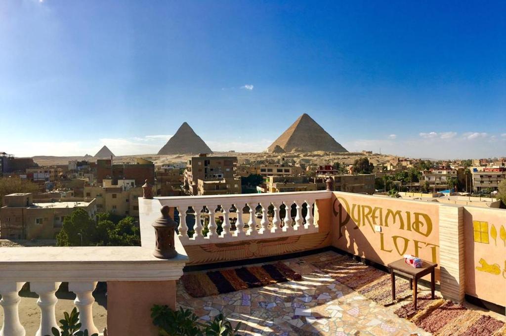 a view of the pyramids from the balcony of a building at The Pyramid Lofts in Cairo