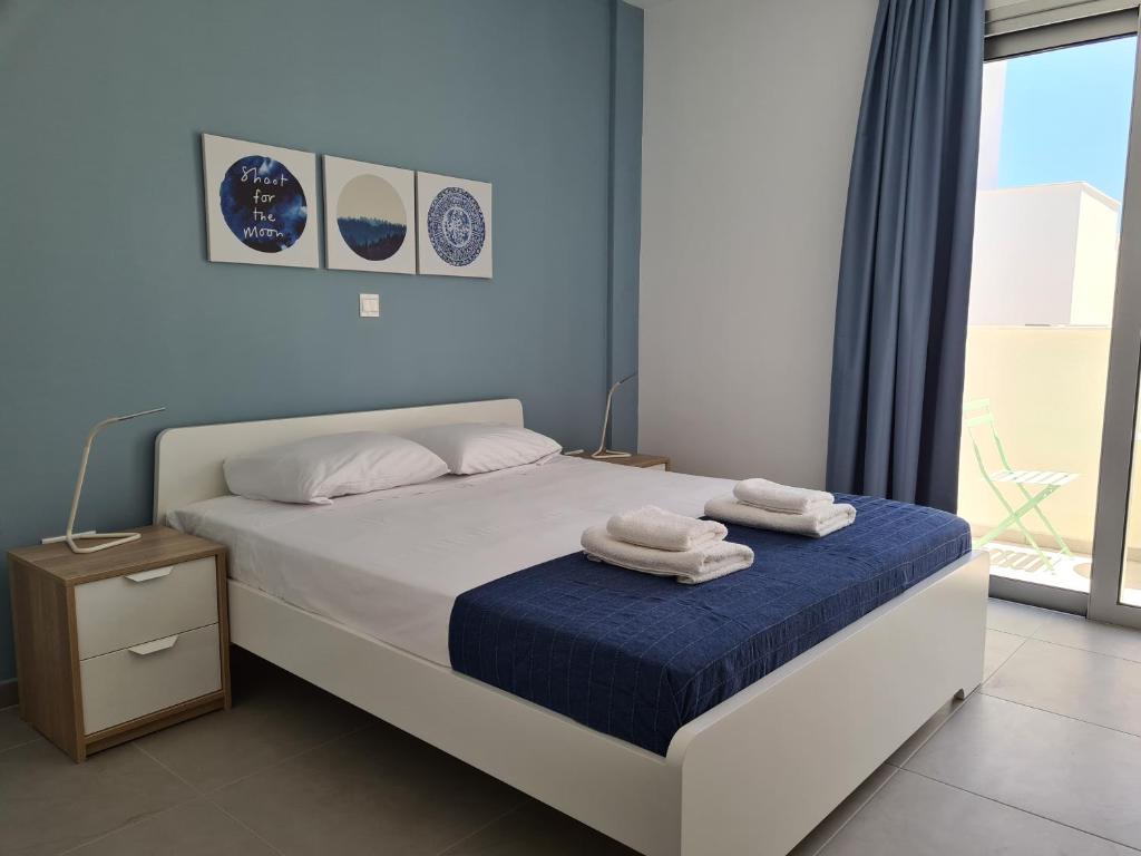 a bedroom with a bed with towels on it at Tefkrou Anthia 9 apts in Ayia Napa