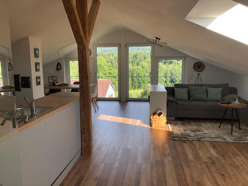 a living room with a couch and a fireplace at Ferienwohnung Samys nahe Lindau am Bodensee in Sigmarszell