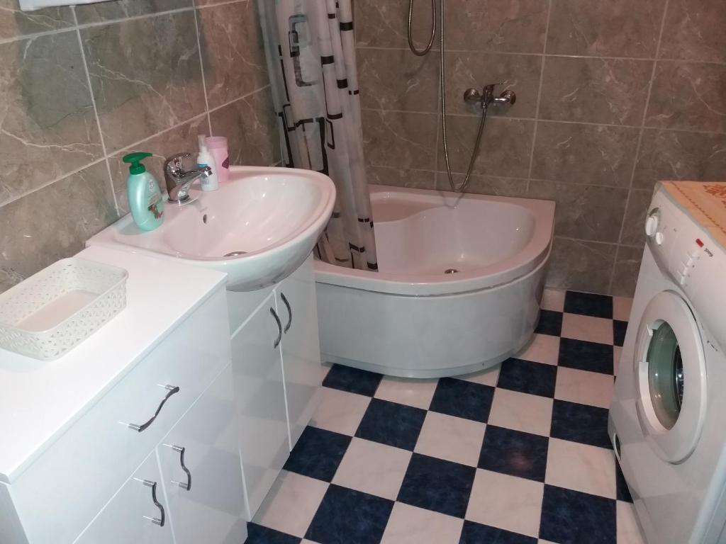 a bathroom with a sink and a tub next to a toilet at Apartments Beka in Žabljak