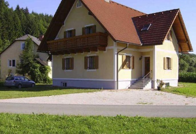 a house with a brown roof and a car in front at Ferienwohnung Hammerlhaus-Zirngast in Eibiswald