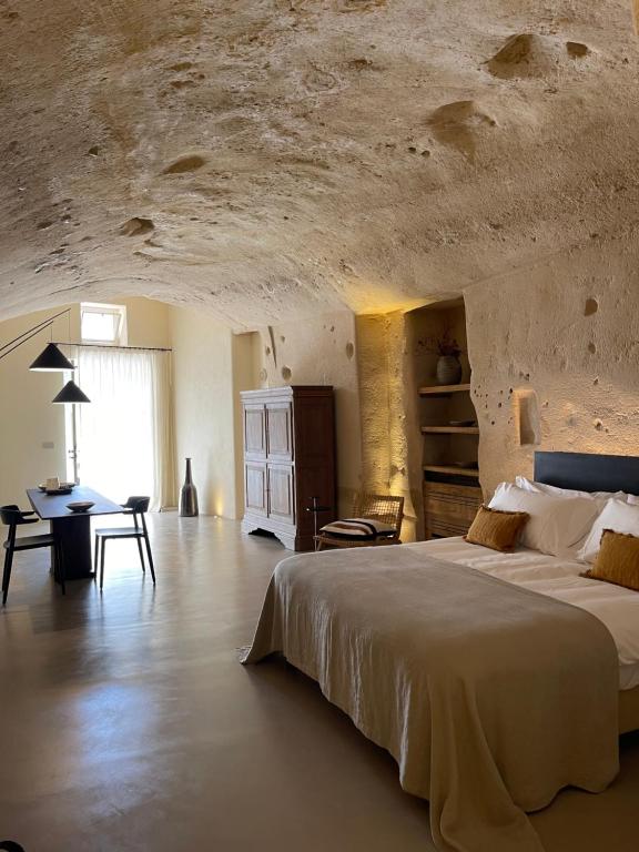 duża sypialnia z dużym łóżkiem i stołem w obiekcie StageROOM02 - Matera w mieście Matera