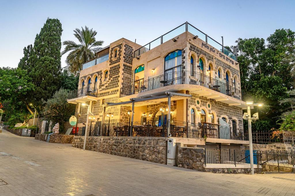 a large building with a clock on the side of it at Shirat Hayam Boutique Hotel in Tiberias