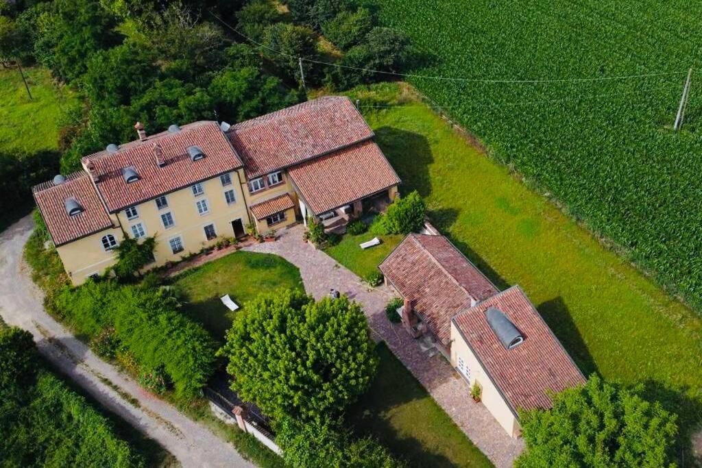 una vista aérea de una gran casa con techos rojos en La casa nei campi, en Badia Pavese