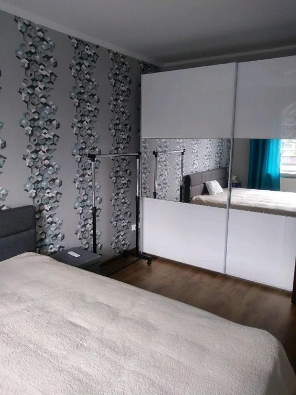 Posteľ alebo postele v izbe v ubytovaní Apartament Mazurski nad Węgorapą