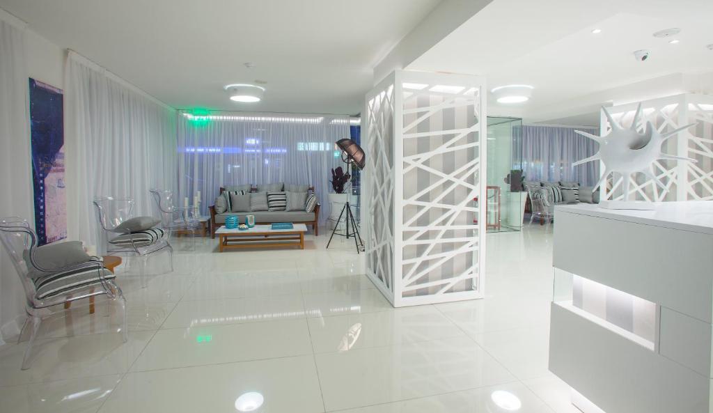 a man is taking a picture of a living room at Princessa Vera Hotel Apartments in Paphos