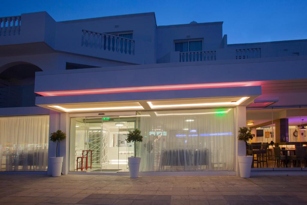 a store front of a building at night at Princessa Vera Hotel Apartments in Paphos