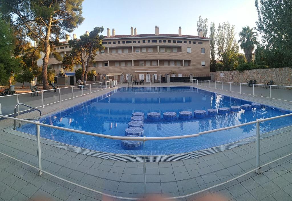 a large swimming pool with a building in the background at ATICO DUPLEX UMA in Benicarló