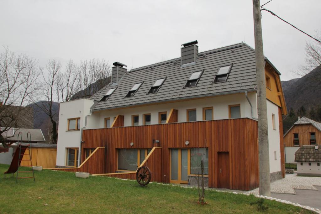 a house with a metal roof on top of it at Apartment MT Čezsoča in Bovec