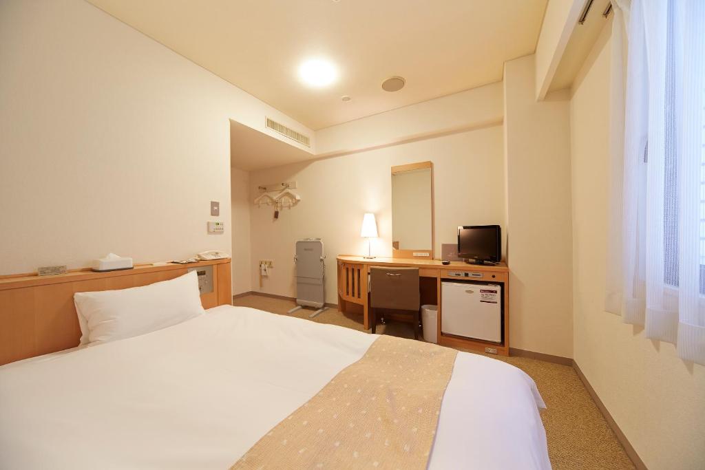 Postel nebo postele na pokoji v ubytování Nest Hotel Kumamoto