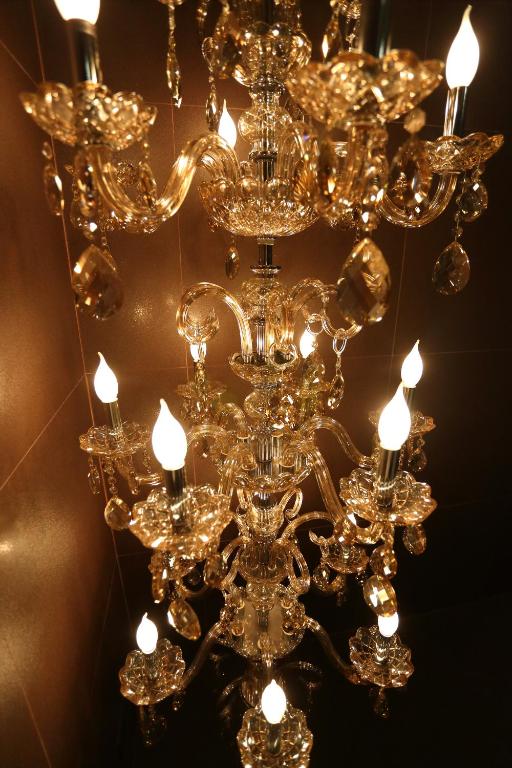 a large gold chandelier hanging from a ceiling at The Fantasy Apartment in Hualien City