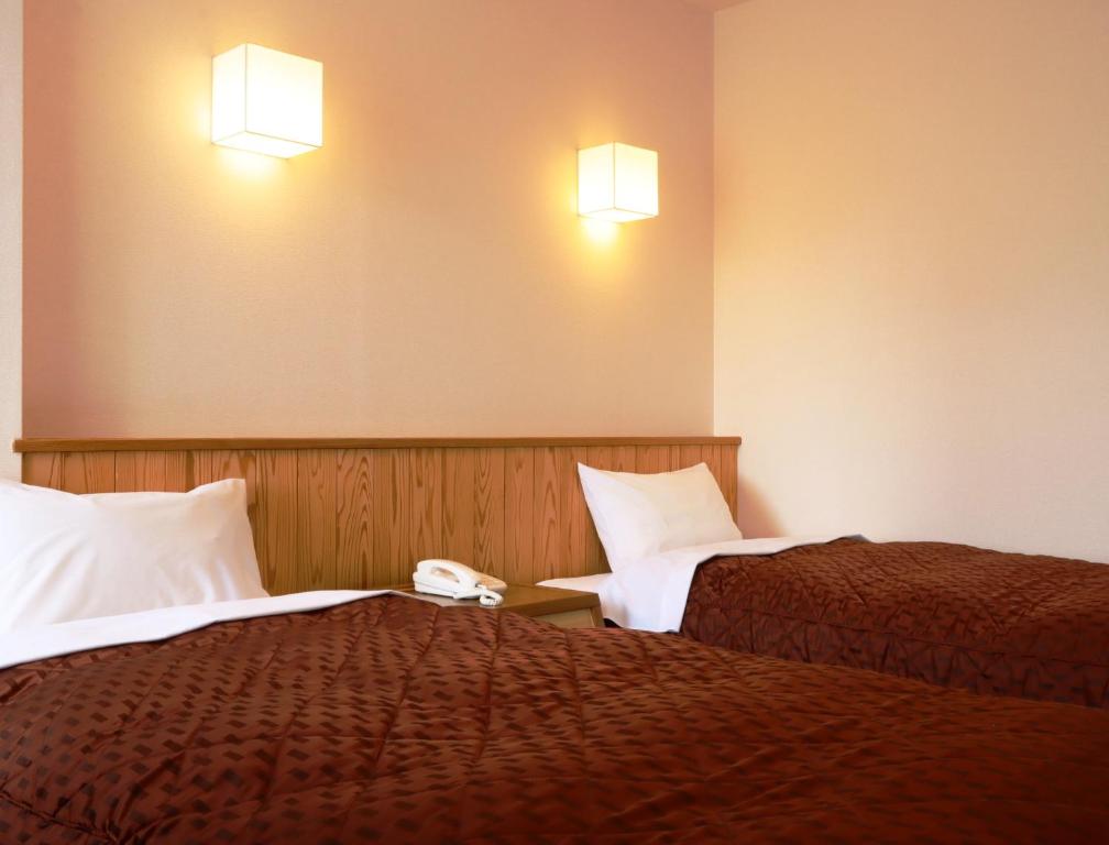 Postel nebo postele na pokoji v ubytování Hotel Cerulean Alpine