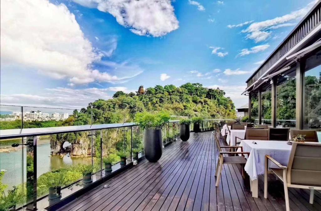 a restaurant with a view of a river at Jolie Vue Boutique Hotel Guilin (near Elephant Trunk Hill) in Guilin