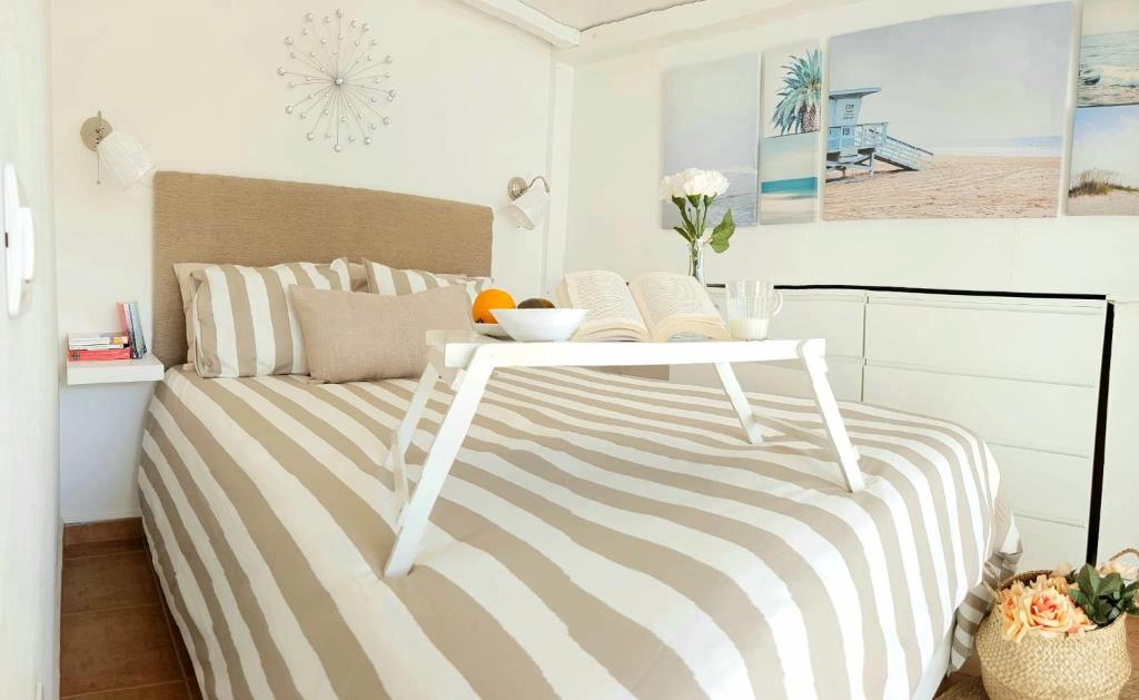a bedroom with a bed with a table on it at Atico en el corazón de Santa Cruz/ Cozy Penthouse in Santa Cruz de Tenerife