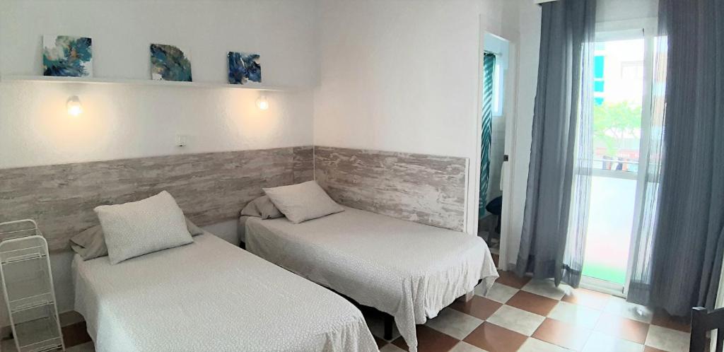 Postel nebo postele na pokoji v ubytování Hostal Nevada