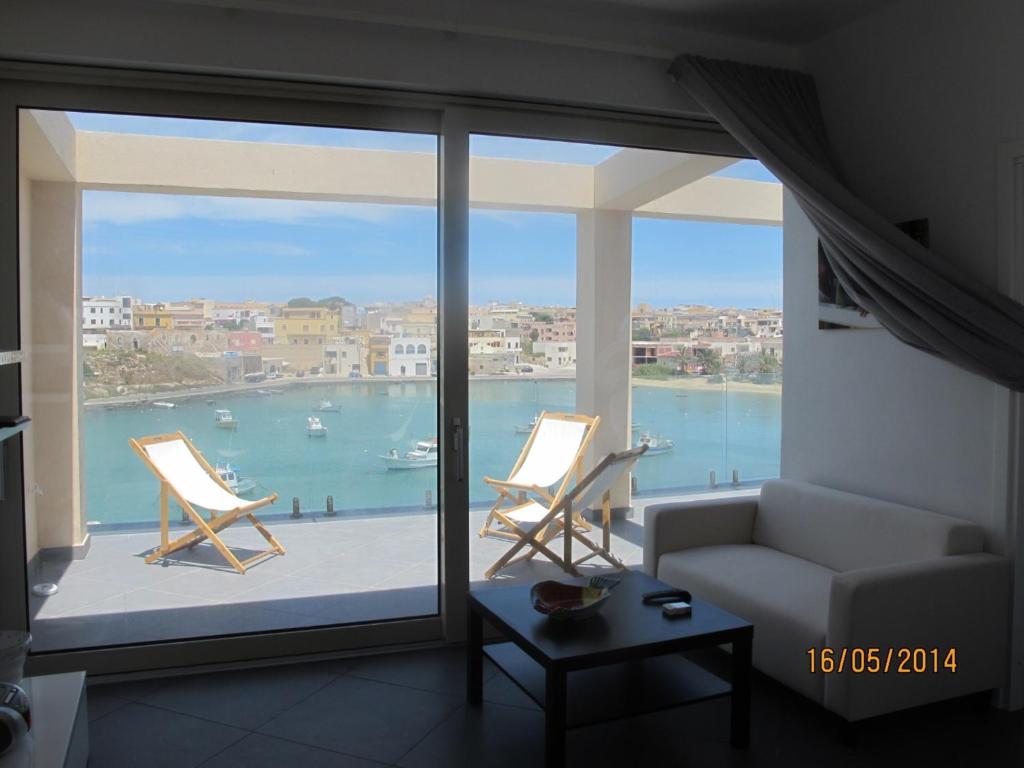 a living room with a view of the water at Cala Maluk in Lampedusa