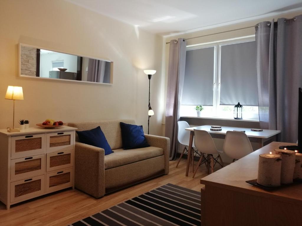 a living room with a couch and a table at Bałtycki Apartment Gdańsk in Gdańsk