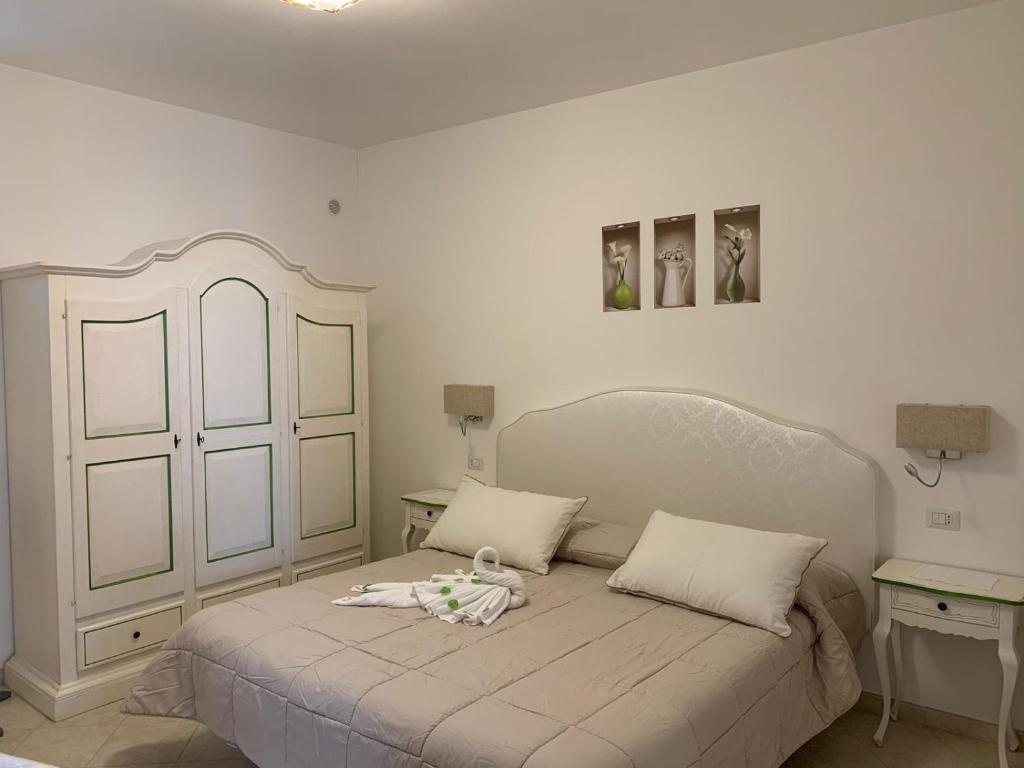 a bedroom with a bed with a doll on it at Appartamento Nonno Francesco in Ravello