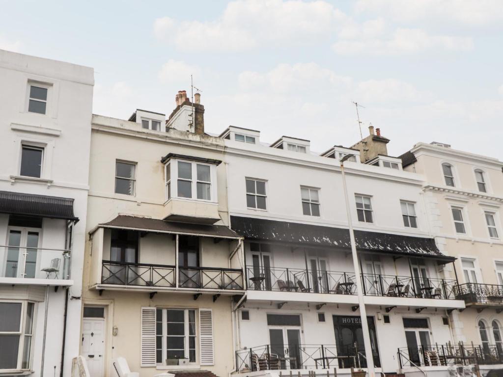a row of white buildings with balconies at Fairlight View in Folkestone