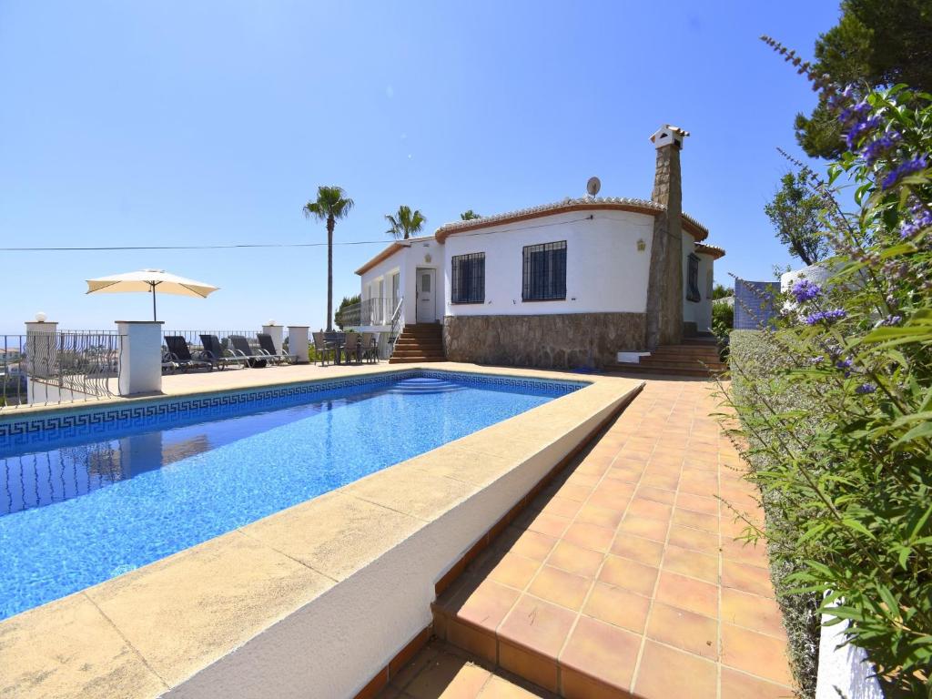 a swimming pool in front of a house at Casa Mahler in Jávea