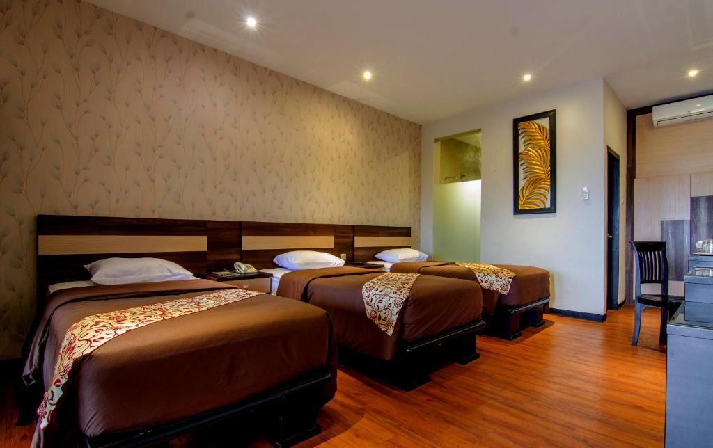 Postel nebo postele na pokoji v ubytování Kusuma Agrowisata Resort & Convention