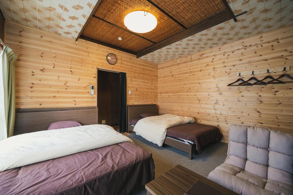Postel nebo postele na pokoji v ubytování Kozaemon
