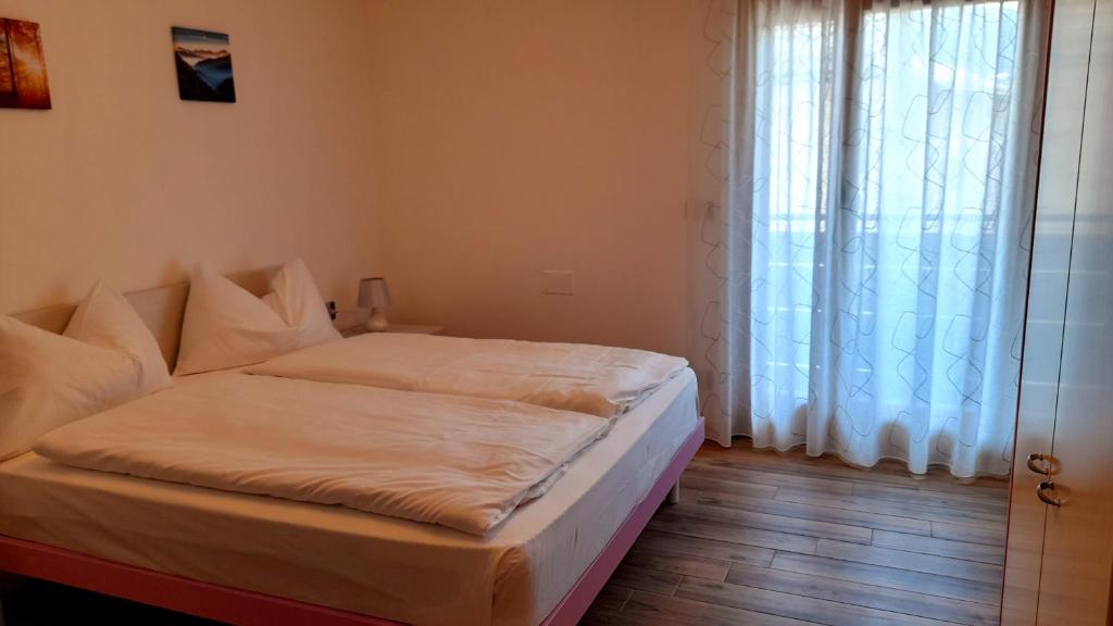 Postel nebo postele na pokoji v ubytování casa vacanze arcobaleno