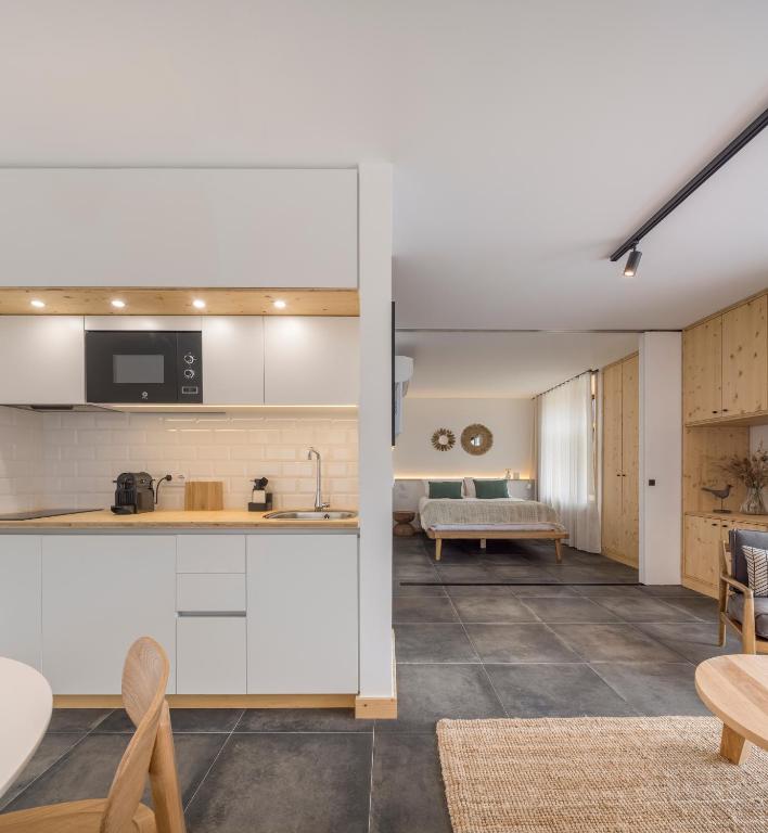 an open kitchen and living room with a couch at Ericeira Prime Villas in Ericeira