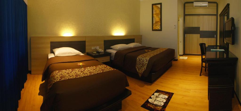 Postel nebo postele na pokoji v ubytování Kusuma Agrowisata Resort & Convention