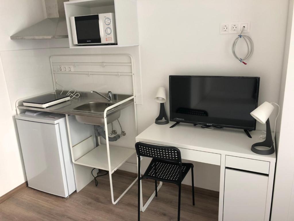 a kitchen with a refrigerator and a microwave at Omega Apartments Budapest in Budapest