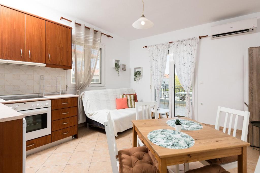 a kitchen and living room with a table and a dining room at Aggelos Apartment in Limenas