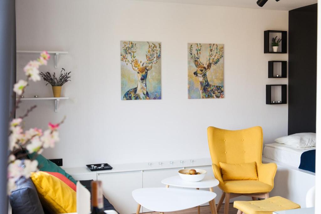 a room with two paintings of deer on the wall at Apartament ZDROJOVY in Busko-Zdrój
