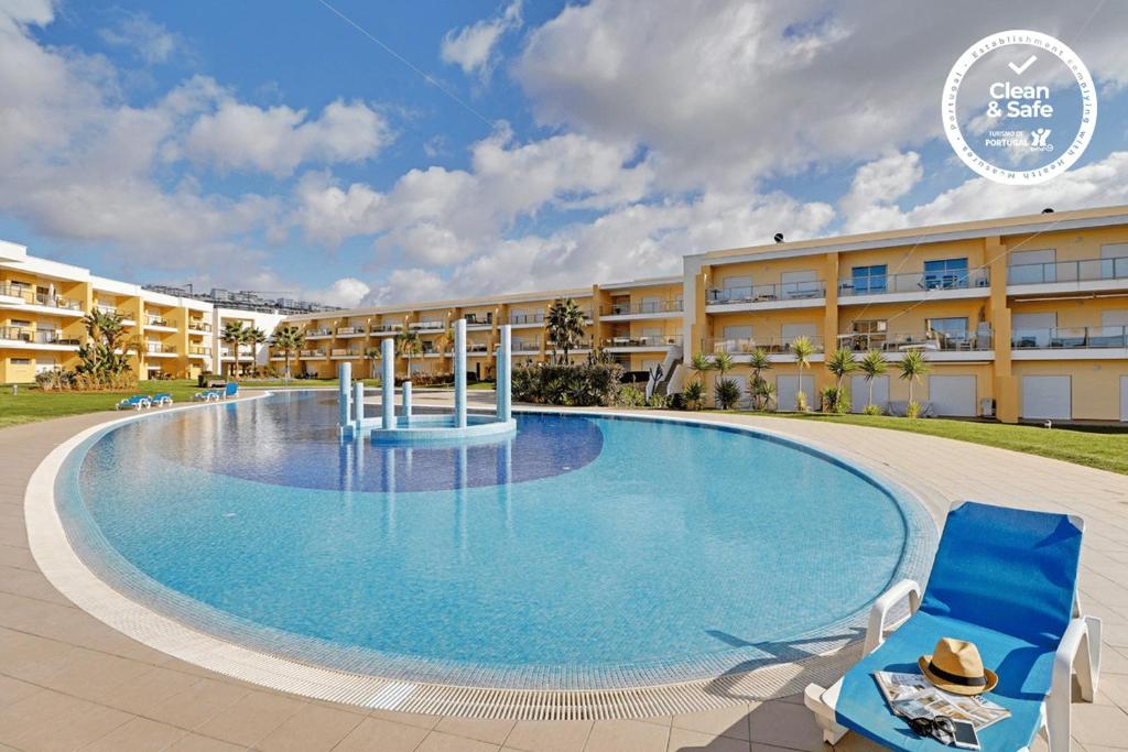 a large swimming pool in front of a building at Albufeira Paradise with Pool by Homing in Albufeira