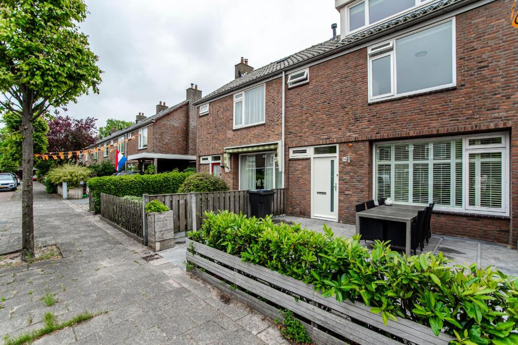 a brick house with a bench in front of it at Family Home Michelle in Zandvoort