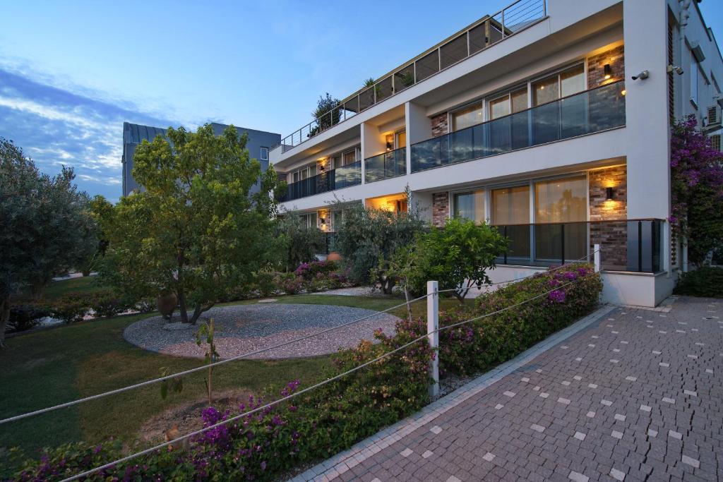 an apartment building with a pathway in front of it at Elia Apartments in Side