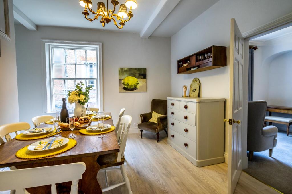 a dining room and living room with a table and chairs at Number One High Petergate in York