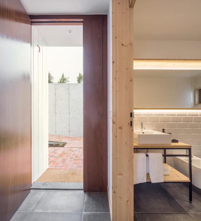 a bathroom with a sink and a mirror at Ericeira Prime Villas in Ericeira