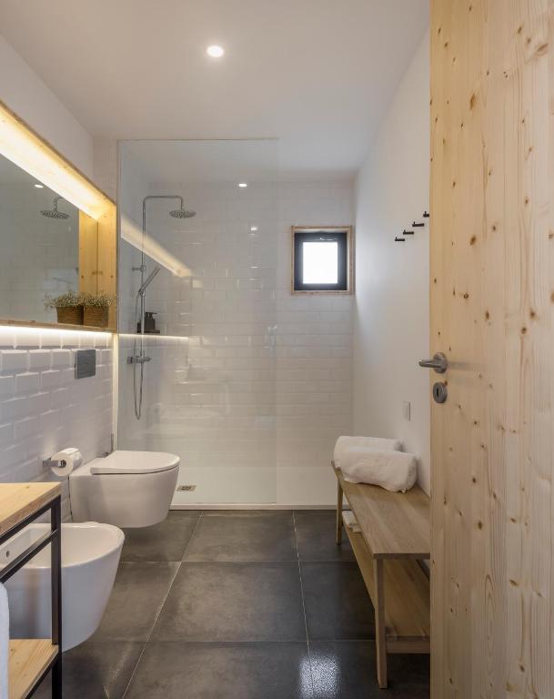 a bathroom with a tub and a toilet and a sink at Ericeira Prime Villas in Ericeira