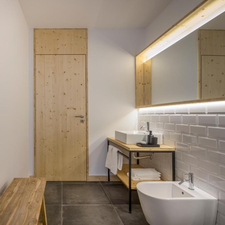 a bathroom with a white sink and a mirror at Ericeira Prime Villas in Ericeira