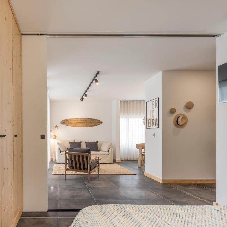 a living room with a couch and a table at Ericeira Prime Villas in Ericeira