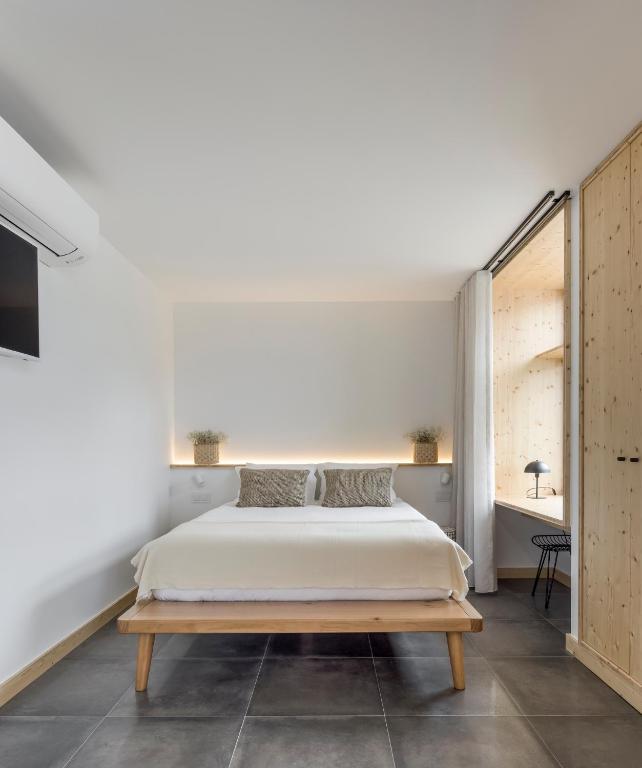 a bedroom with a bed and a large window at Ericeira Prime Villas in Ericeira