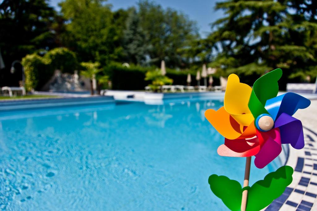 a colorful pinwheel next to a swimming pool at Abano Ritz Hotel Terme in Abano Terme