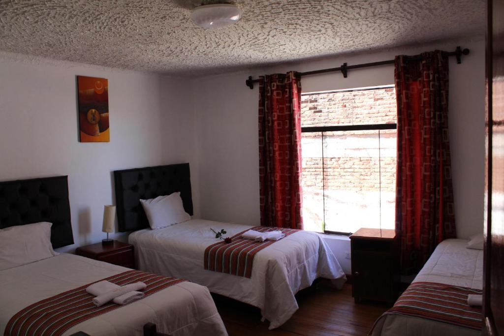 Postel nebo postele na pokoji v ubytování KAARO HOUSE CUSCO