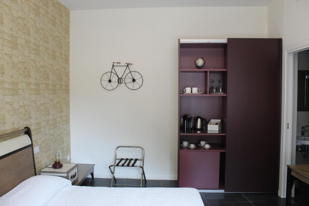 a bedroom with a bed and a bike on the wall at Cetara Costa d'Amalfi Residence in Cetara