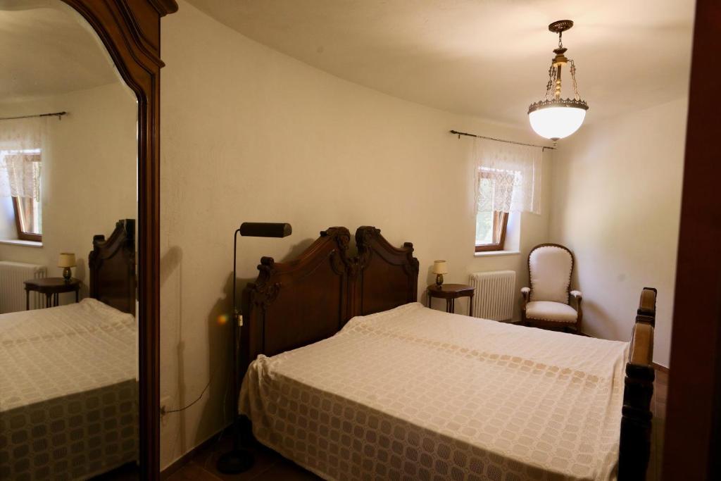 a bedroom with two beds and a mirror at Mountains Villa near Budva in Budva