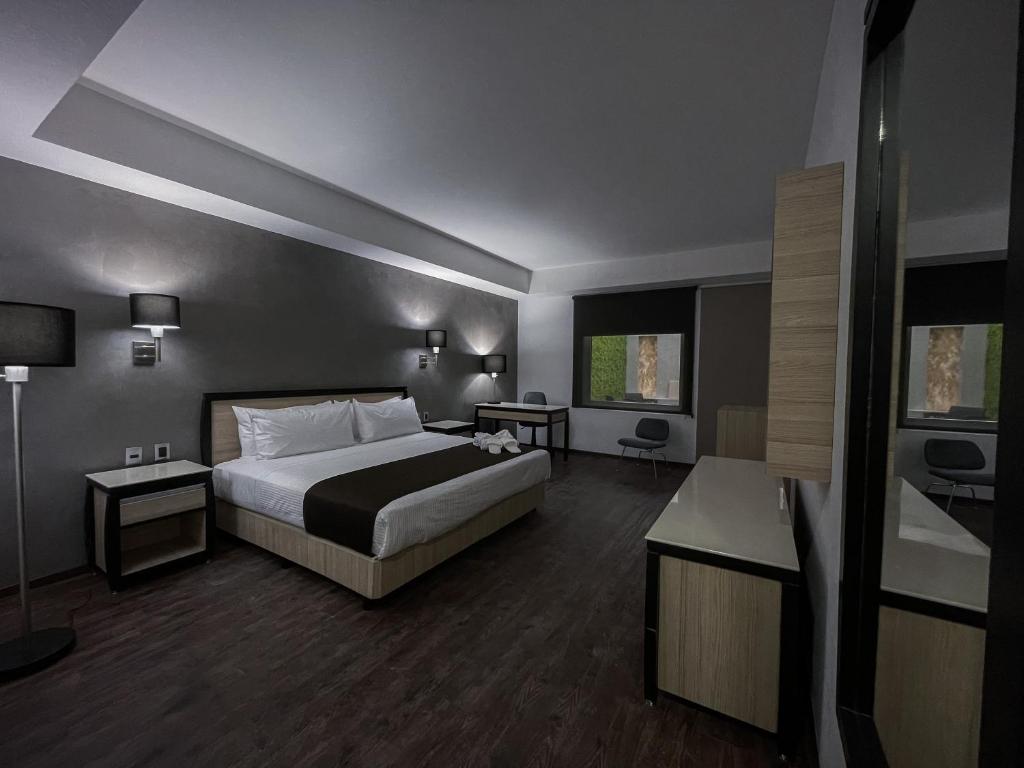 Postel nebo postele na pokoji v ubytování Fato Hotel